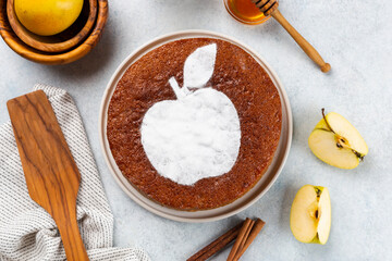 Homemade apple pie on a white wooden background, top view. The classic autumn dessert for Thanksgiving is organic apple pie.