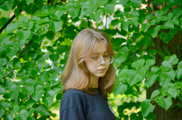 the girl is photographed near the greenery, portrait