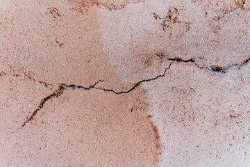 adobe old cracked wall close up background