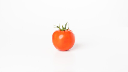 Tomato with a branch on a white background close-up vegetable