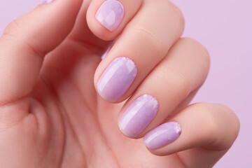 Womans hand with trendy lavender manicure. Spring summer nail design.