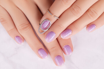 Womans hands with trendy lavender manicure. Spring summer nail design
