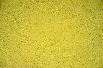 Naklejka premium Photo of the texture of the wall painted with yellow paint. Yellow concrete wall. The background is yellow for the text.