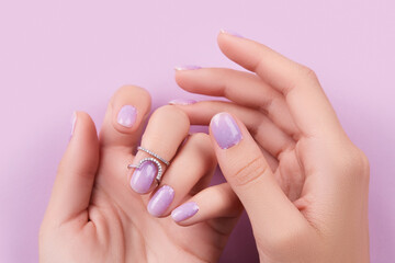 Womans hands with trendy lavender manicure. Spring summer nail design