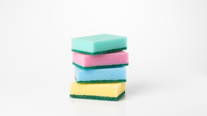 Multicolored sponges in a stack on a white background