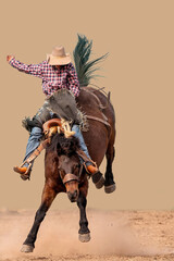 Cowboy riding a bucking bronc at a country rodeo Australia. Background replaced. © Jackson Photography