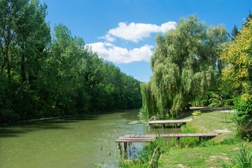 River creek of the Danube river in Bezdan, Sombor, Serbia on nice summer afternoon with little boat...