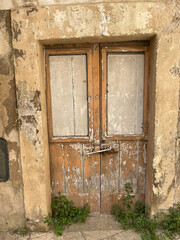 Sicilian Still Life Old wooden doors on ancient building with peeling paint