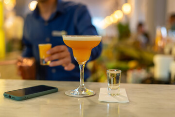 Blurred photograph, An alcoholic cocktail prepared at the bar.