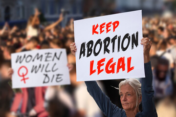 Protesters holding signs saying Keep Abortion Legal and Women Will Die. Women with placards supporting abortion rights at protest rally demonstration. Concept image. - obrazy, fototapety, plakaty