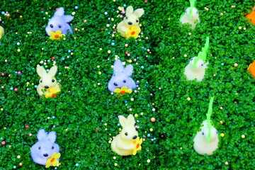 Colorful Easter bunnies in green grass