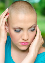 Happy young woman cancer survivor in summer nature	