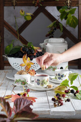 fruit tea with ripe blackberries, vintage still life with beautiful retro set 