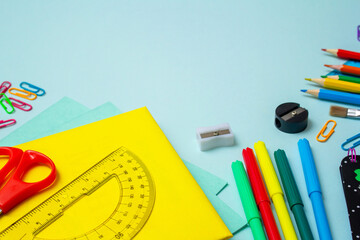 back to school, school supplies, on a blue background, pencil sharpener, book, pencils, felt-tip...