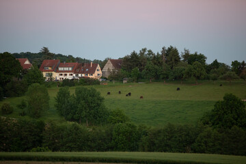 Fototapeta na wymiar Rural landscape european village summer sunset kettle on the field calm view