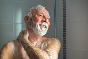 Senior man taking a shower in the bathroom in the morning - 521097072