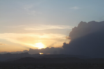 Wildfire smoke can be seen nearly blocking the desert sunset with mountains in the foreground
