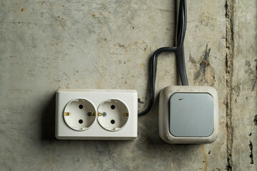 temporary switch and socket on a concrete wall