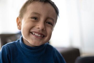 Handsome boy, 2-3 years old smiling in the living room