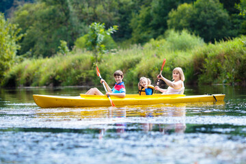 Child on kayak. Kids on canoe. Summer camping.