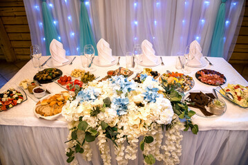 Table with food and drinks for wedding guests