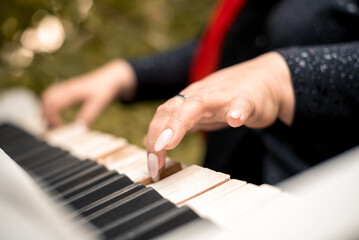 Fototapeta premium close-up female hands playing the piano