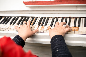 close-up female hands playing the piano