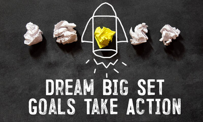 Dream Big Set Goals Take Action text quote on notepad, concept background.