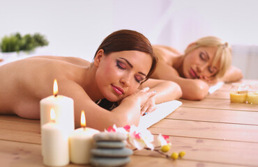 Obraz na płótnie Canvas Two young beautiful women relaxing and enjoying at the spa center