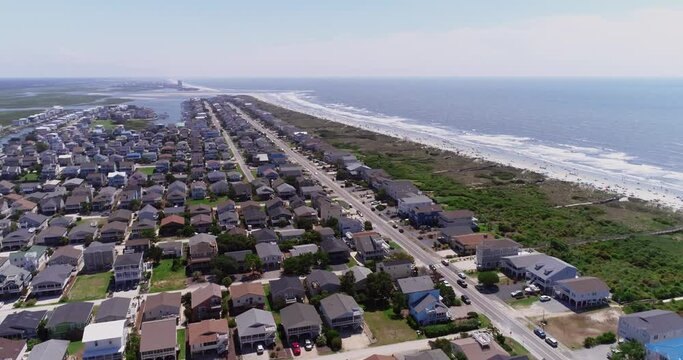 Drone shot of Sunset beach houses along the ocean near North Myrtle Beach and Ocean Isle