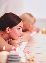 Fototapeta na wymiar Two young beautiful women relaxing and enjoying at the spa. Two young beautiful women relaxing