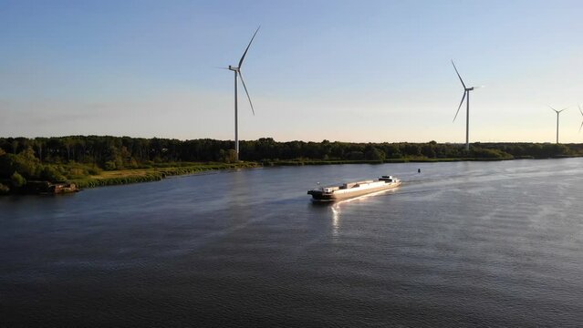 Aerial Drone Shot Of FPS Waal Inland Cargo Vessel Along Oude Maas With During Golden Hour. Establishing Shot