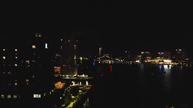 Gorgeous long flight away from July 4th celebration in Norfolk, Virginia.   Brilliant colorful aerials and fireworks fill the city sky in this colorful display.  Great cityscape showcasing downtown.