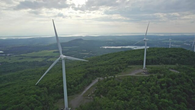 Close up drone shot of windmills ona cloudy day in Vermont. 