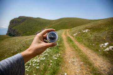 A male is looking for a compass in the mountains