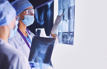 Two female women medical doctors looking at x-rays in a hospital.