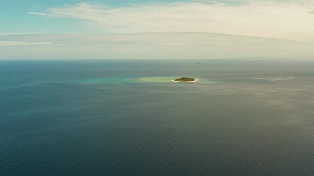 Small tropical island on an atoll with beautiful sandy beach in blue sea. Tropical island and coral reef. Summer and travel vacation concept, Camiguin, Philippines, Mindanao