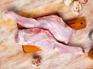 Home cooking. Pieces of fresh raw young lamb shoulder and condiments prepared for roasting on...