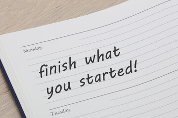 Obraz premium Finish what you started diary reminder appointment open on desk