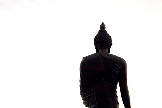 statue of Buddha is a sacred and revered Buddha image located outdoors inside the school for students to pay their respects in the evening blue sky and see the serene atmosphere and white background.