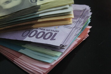 ten thousand rupiahs among many rupiahs of various nominal