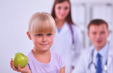 Fototapeta premium Female doctor examining child with stethoscope at surgery