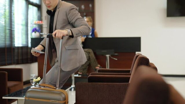 4K Asian businessman leave airport private lounge on boarding time in airport terminal. Airline service business, airplane transportation and holiday vacation concept