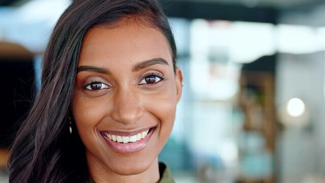 Closeup face portrait of happy, beautiful young woman smiling and laughing while looking into camera. Fun, charming attractive female with a smile of joy. Expressive lady standing with lovely grin