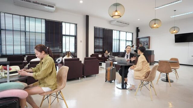 Group of People relax and working at airport private lounge and waiting for boarding in international airport terminal. Airline service business, airplane transportation and holiday vacation concept