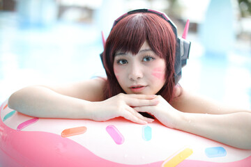 Portrait of Japan anime cosplay girl with swim suit at swimming pool