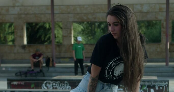 beautiful girl posing without looking at camera in a skate park.