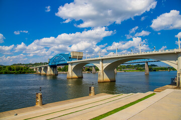 a gorgeous summer landscape on the Tennessee River with the Chief John Ross Bridge over the water...