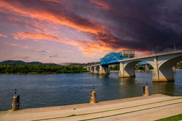a gorgeous summer landscape on the Tennessee River with the Chief John Ross Bridge over the water...