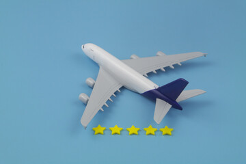 Fototapeta na wymiar Reputation of airlines company. Airplane with five stars stickers on blue background. 